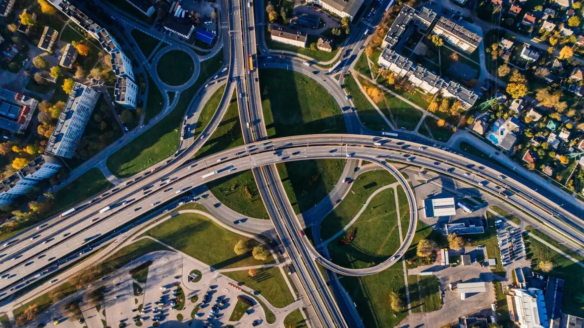 Aerial photograph of infrastructure motorways, roundabout and buildings.